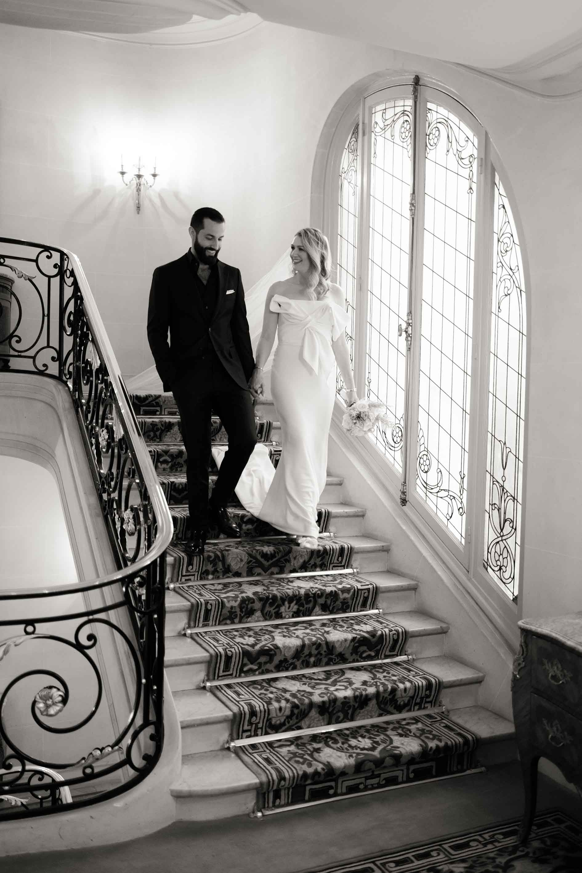 the bride and groom descend the steps of